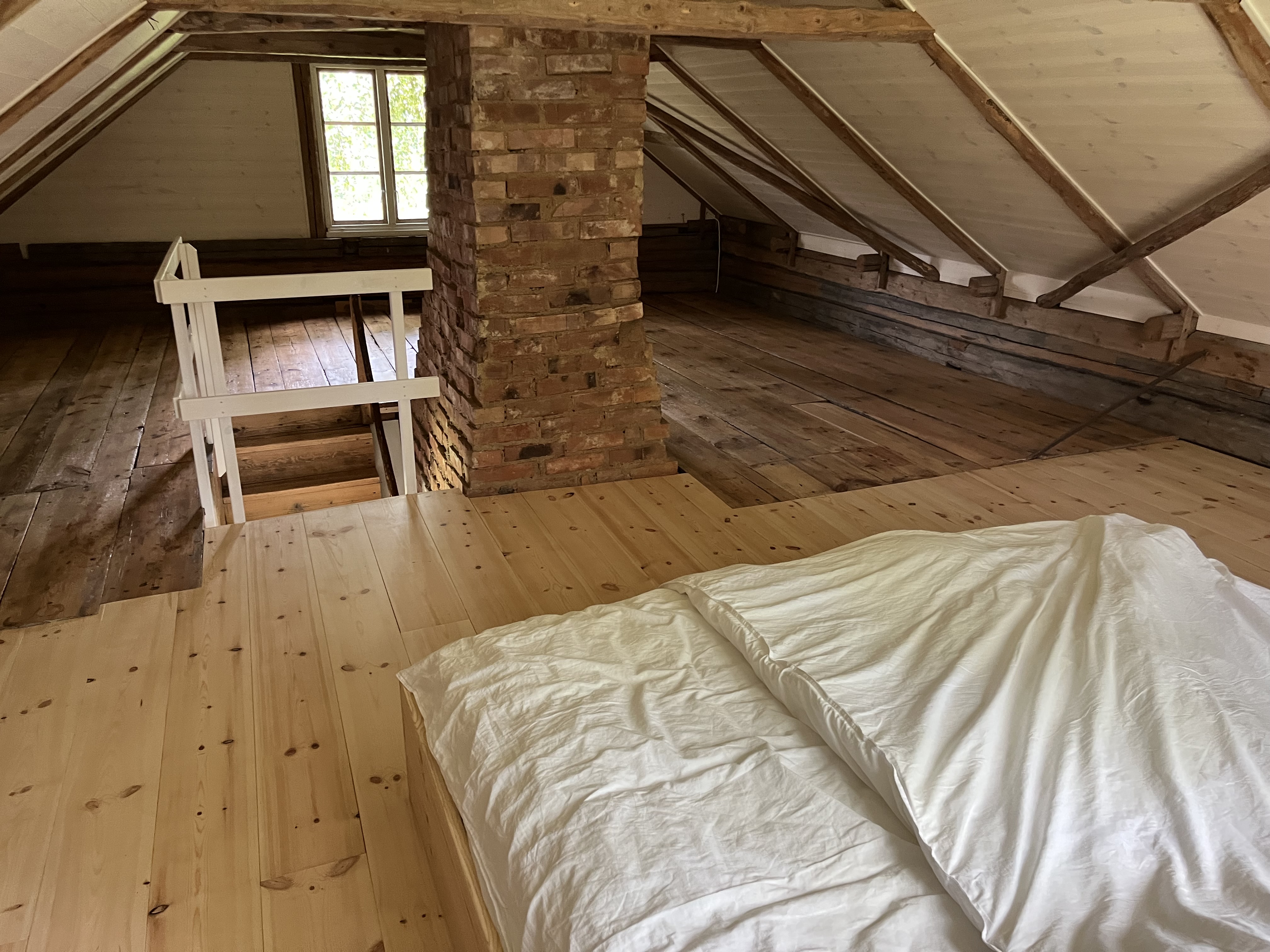 Small bedroom with double bed, big window and shared en-suite bathroom